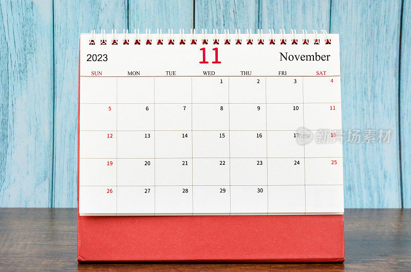The November 2023 Monthly desk calendar for the organizer to plan 2023 year on wooden table.